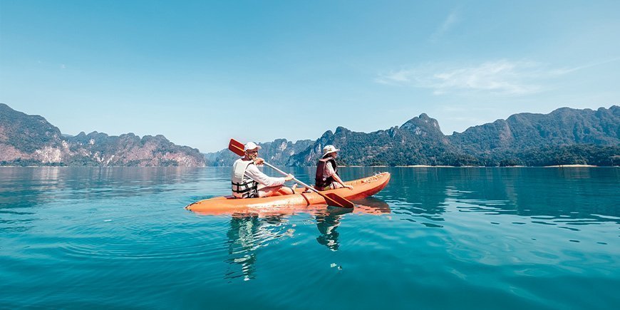 Vader en zoon kajakken op het meer in Khao Sok National Park